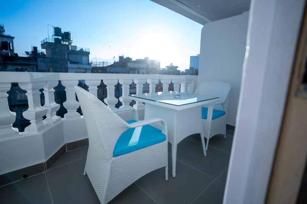 a white table and chairs on a balcony at Hotel Crown Plaza in Kathmandu