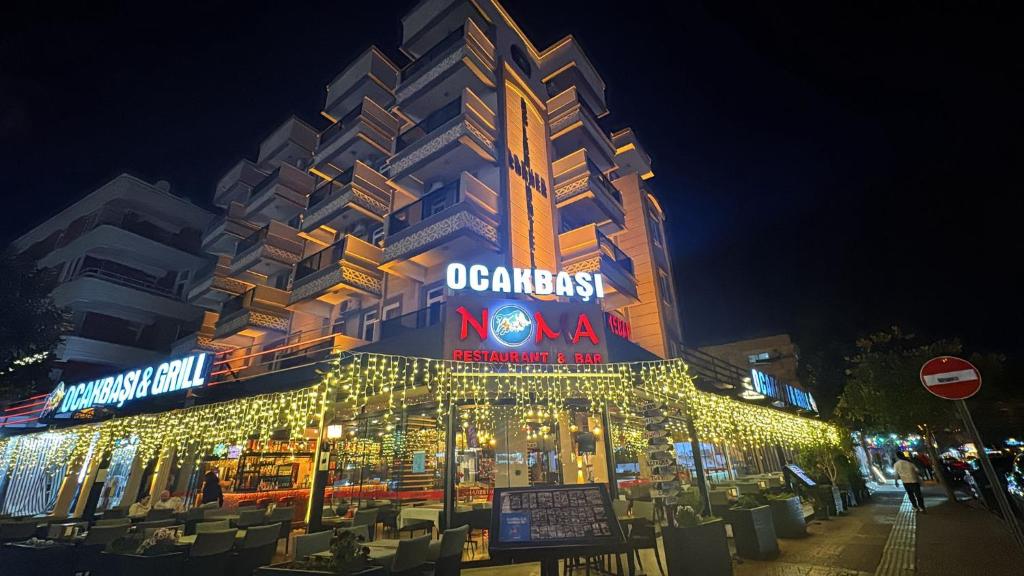 a building with christmas lights in front of it at Aslan Corner Hotel in Alanya