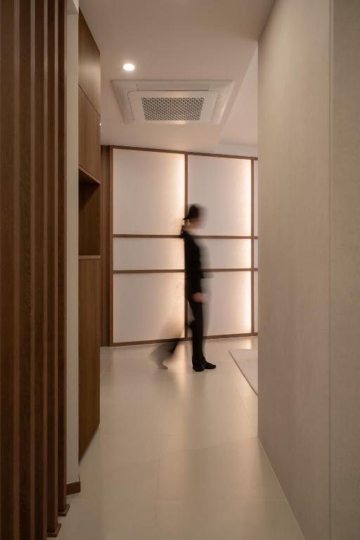 a person walking in a hallway with a wall at StayShim in Seoul