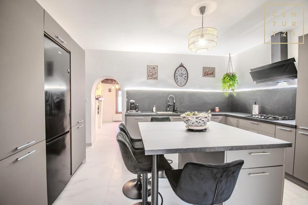 a kitchen with a counter and a refrigerator at Philippe chez l'habitant in Maubeuge