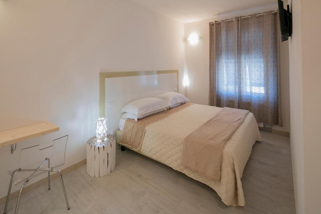 A bed or beds in a room at Affittacamere Margherita
