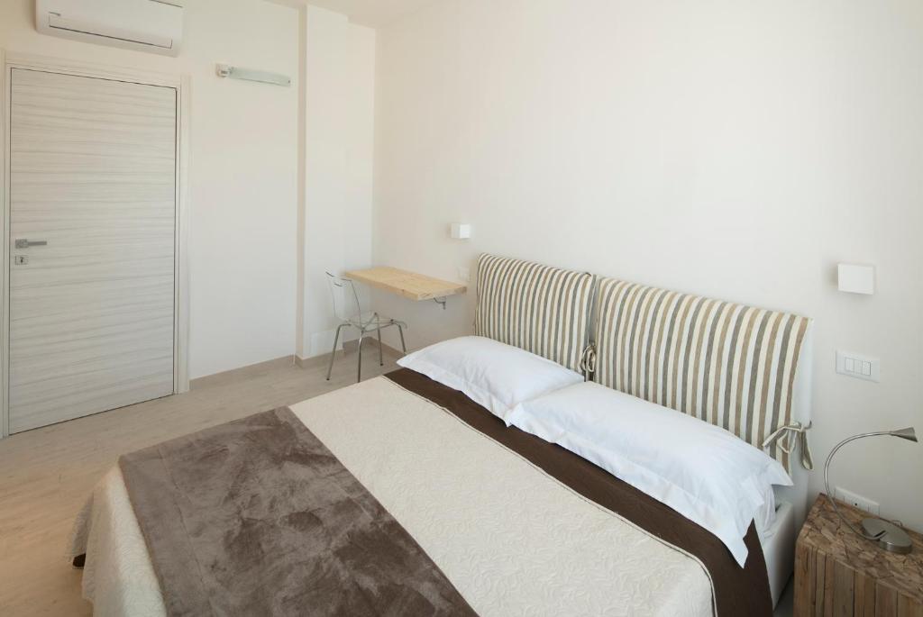 A bed or beds in a room at Affittacamere Margherita