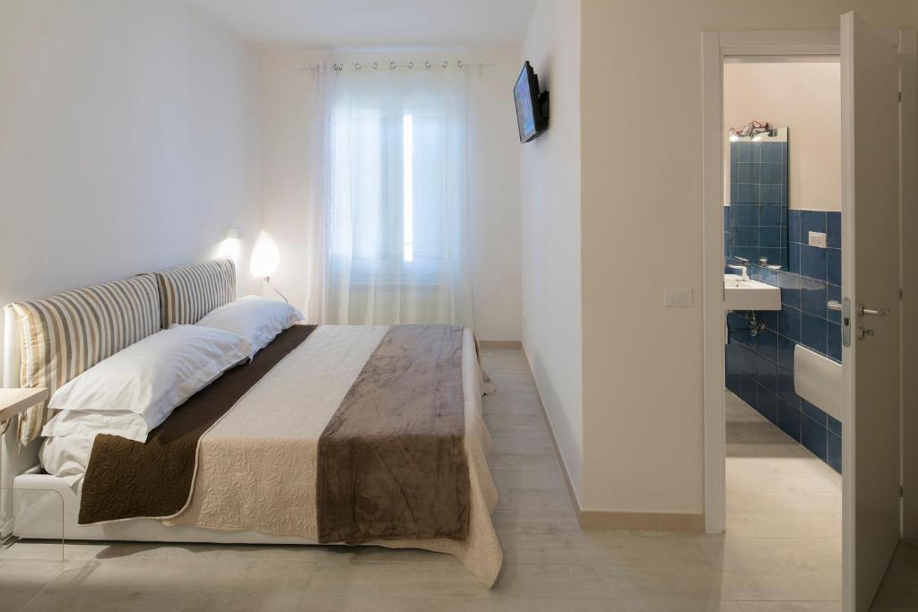 A bed or beds in a room at Affittacamere Margherita
