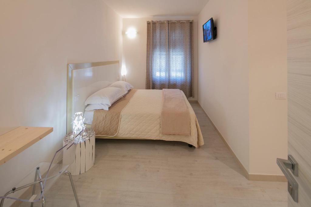 A bed or beds in a room at Affittacamere Margherita