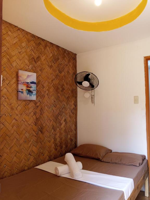 a bedroom with a bed with a banana on the ceiling at C and C Place in San Vicente