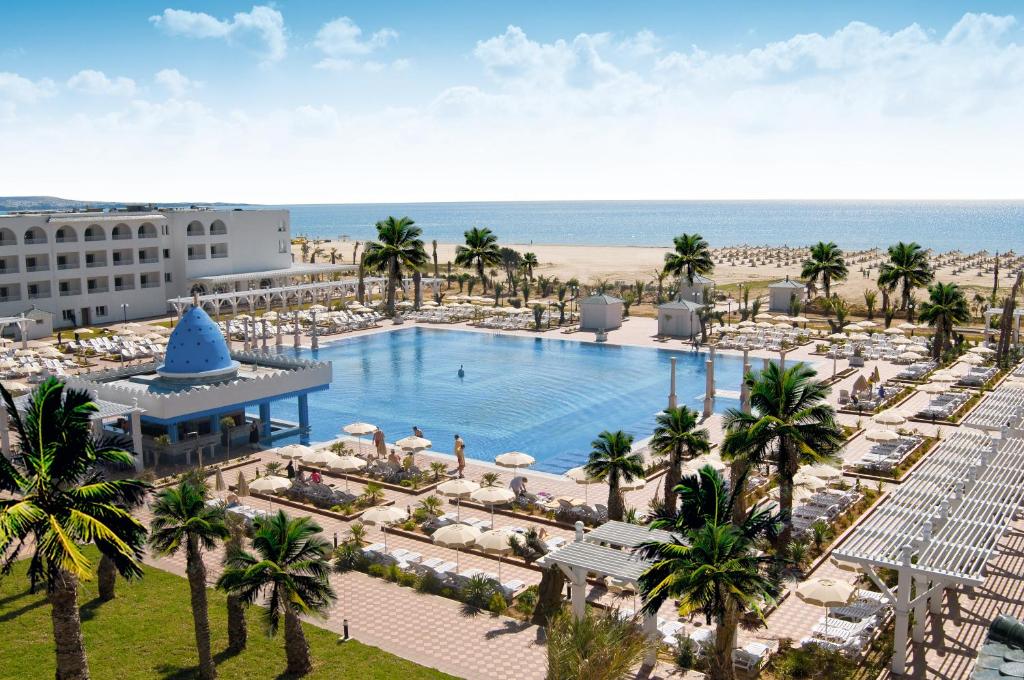 an aerial view of a resort with a swimming pool and the beach at Occidental Marco Polo in Hammamet