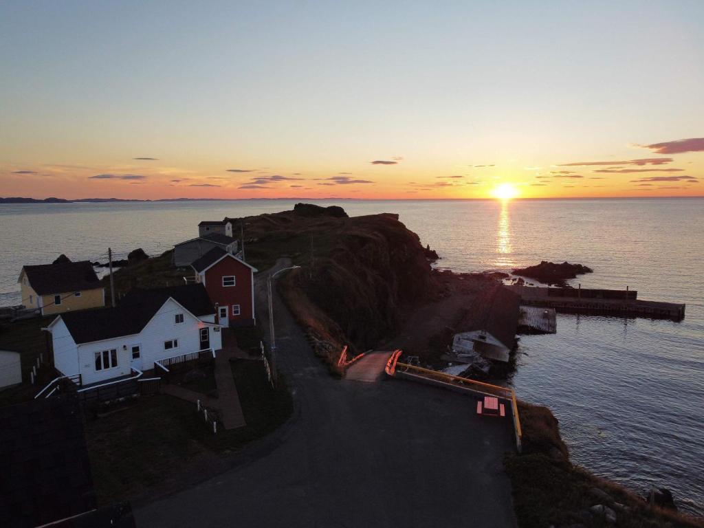 a sunset over a small island in the water at The Moose Twillingate Island in Twillingate