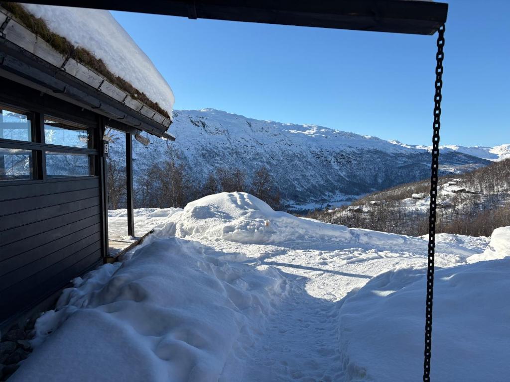 a pile of snow in front of a building at Cosy cabin in Hemsedal with ski in-ski out to Solheisen in Hemsedal