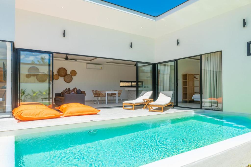a house with a swimming pool and a living room at Villa Laura 2Br & Private Pool in Mae Nam in Mae Nam