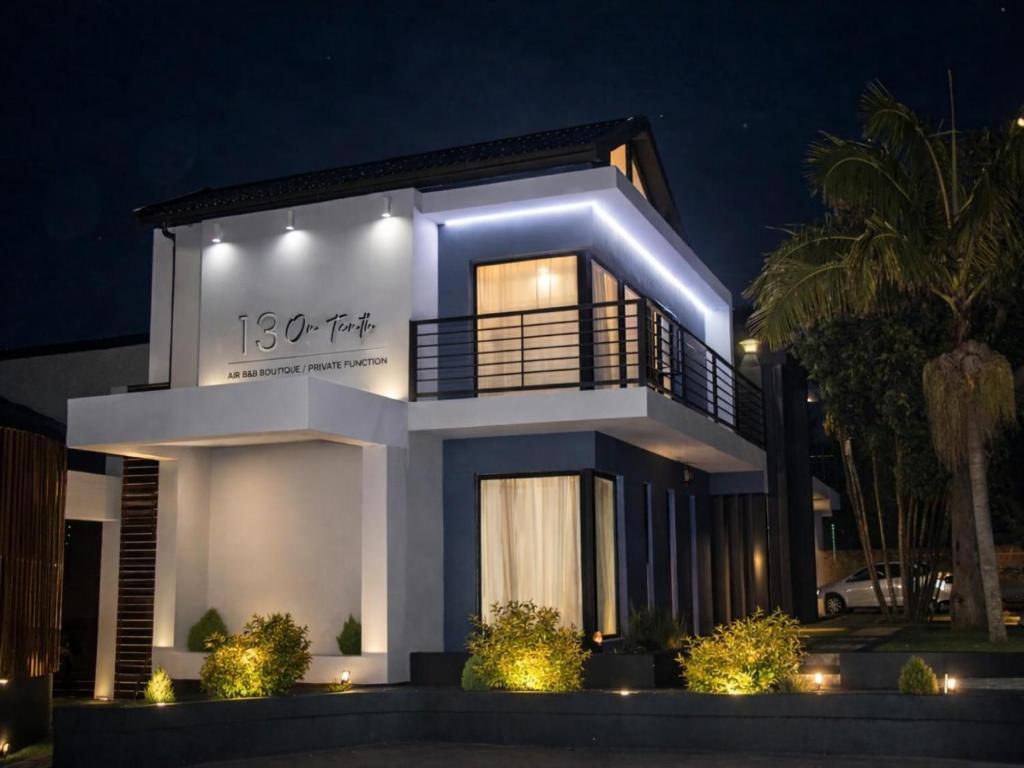 a large white house with lights on it at night at 13 on Tenth in Walmer