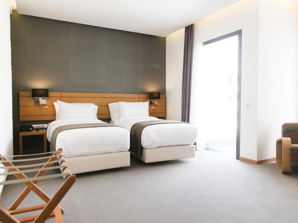 En eller flere senge i et værelse på Smarts Hotel Agdal Rabat
