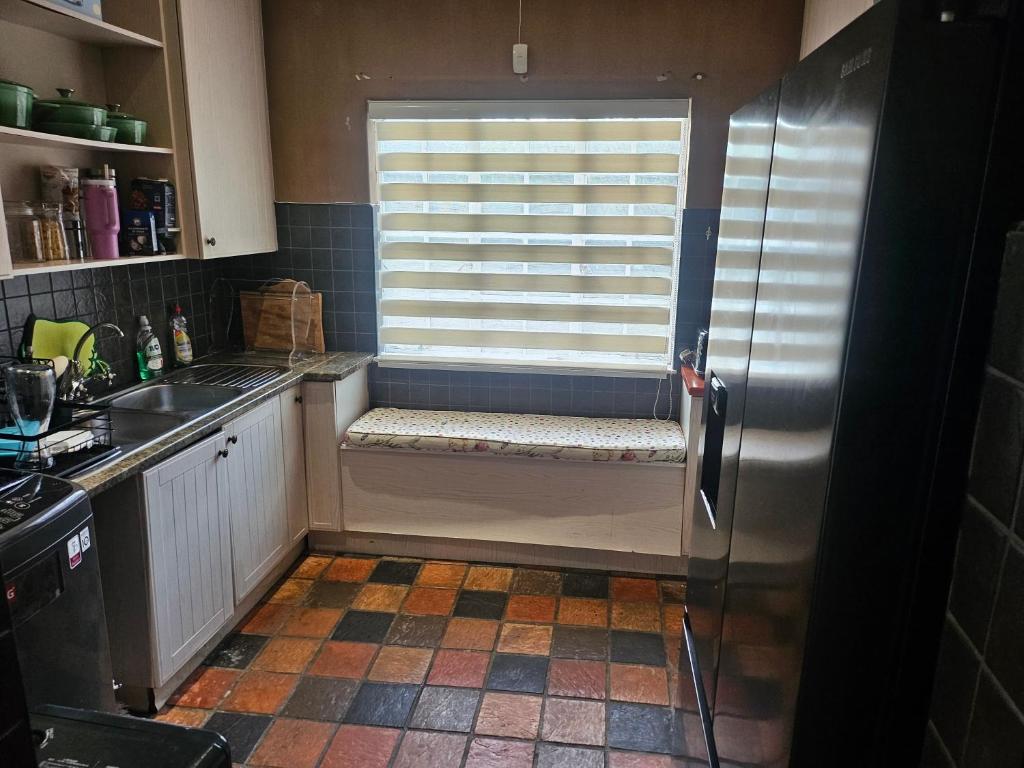a kitchen with a window with a bench in front of it at 20 in Crescent in Gqeberha