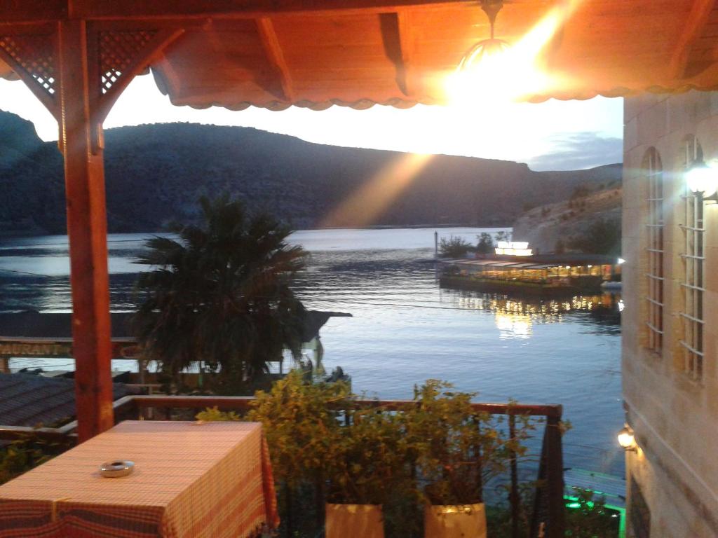a view of a lake from a balcony with a view at Socrates Hotel Halfeti in Halfeti
