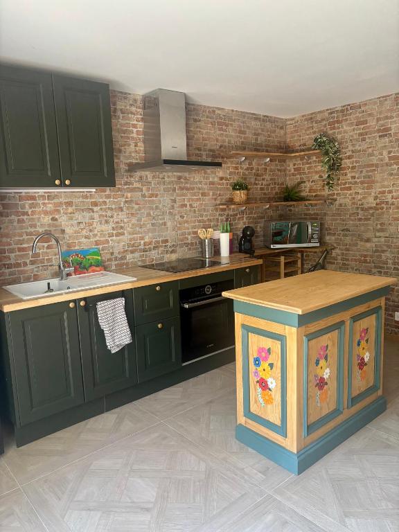 a kitchen with green cabinets and a counter top at Loft dans les vignes in La Cadière-dʼAzur