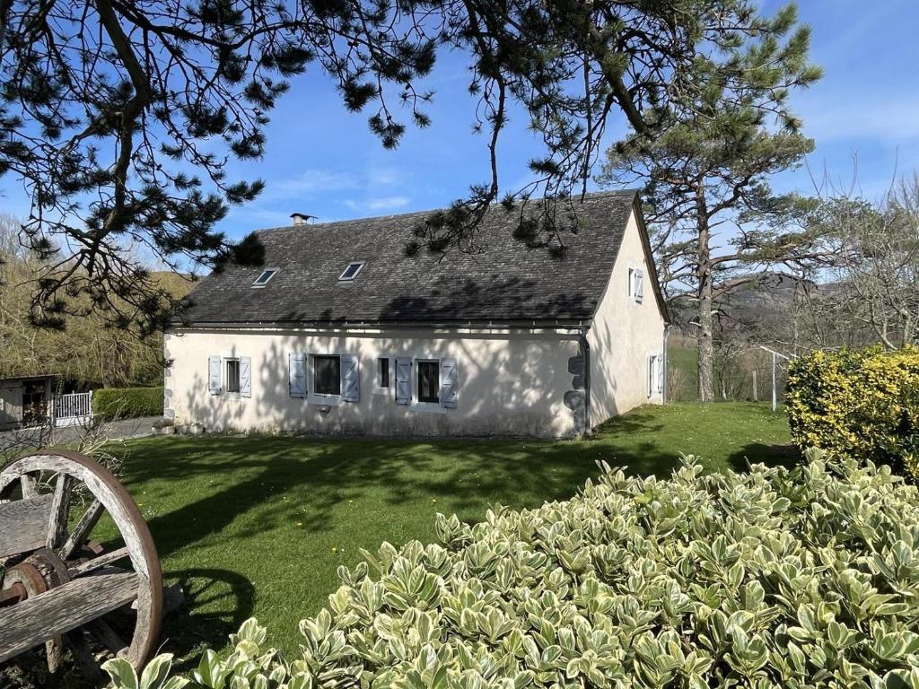 a white house with a yard with a bench at Chez escarain in Arette