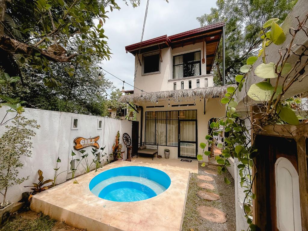 a house with a swimming pool in the yard at Chill Tangalle in Tangalle