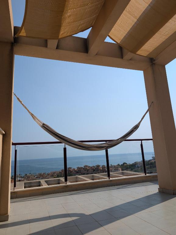 a large window in a building with a hammock at Hamaca & Sea in Cartagena