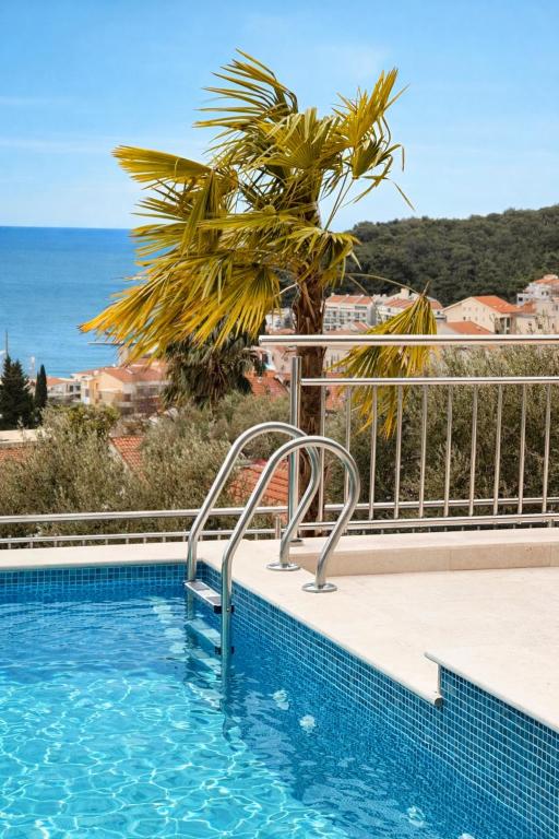 a swimming pool with a view of the ocean at Olive apartments in Petrovac na Moru