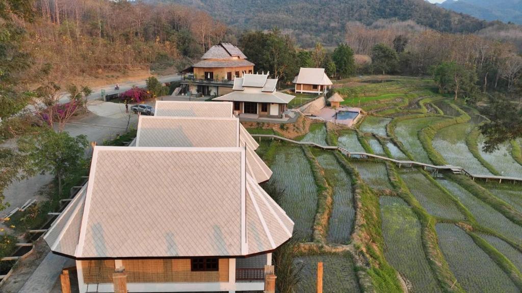 an aerial view of a house in a field at KuangSi Resort in Luang Prabang