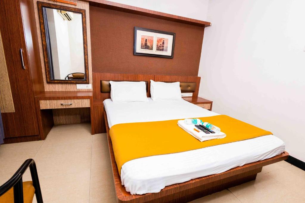 a bedroom with a large bed with a mirror at Hotel DRG Heritage in Tiruppūr
