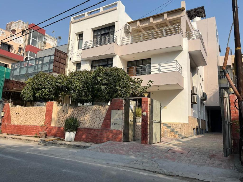 a white building on the side of a street at NICE Stay & Care in Noida