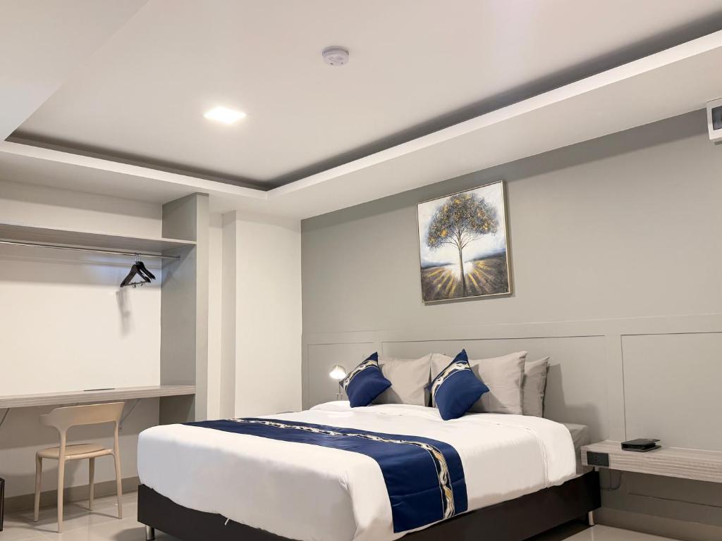 A bedroom-focused view with a double bed, bedside table and built-in desk.