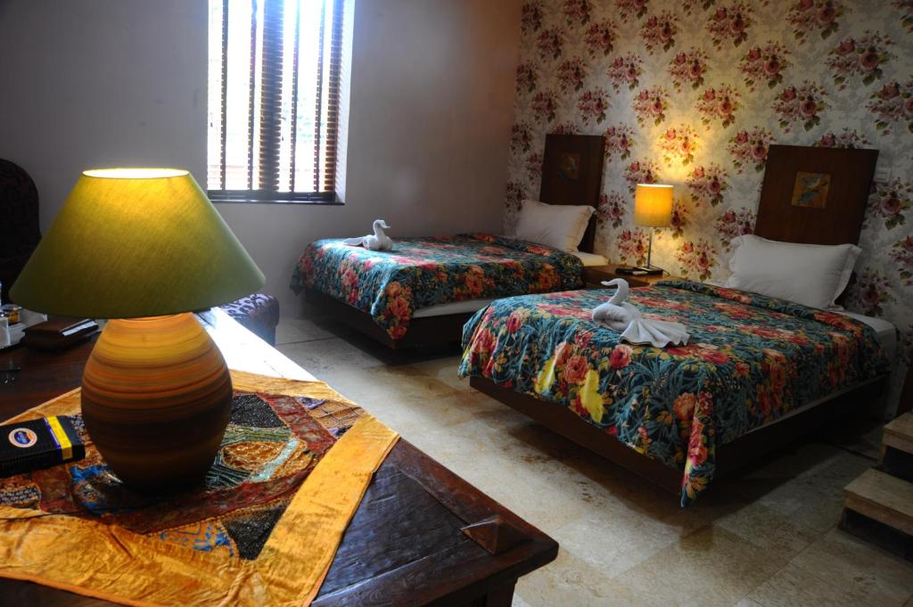 Postel nebo postele na pokoji v ubytování Tegal Panggung Guest House