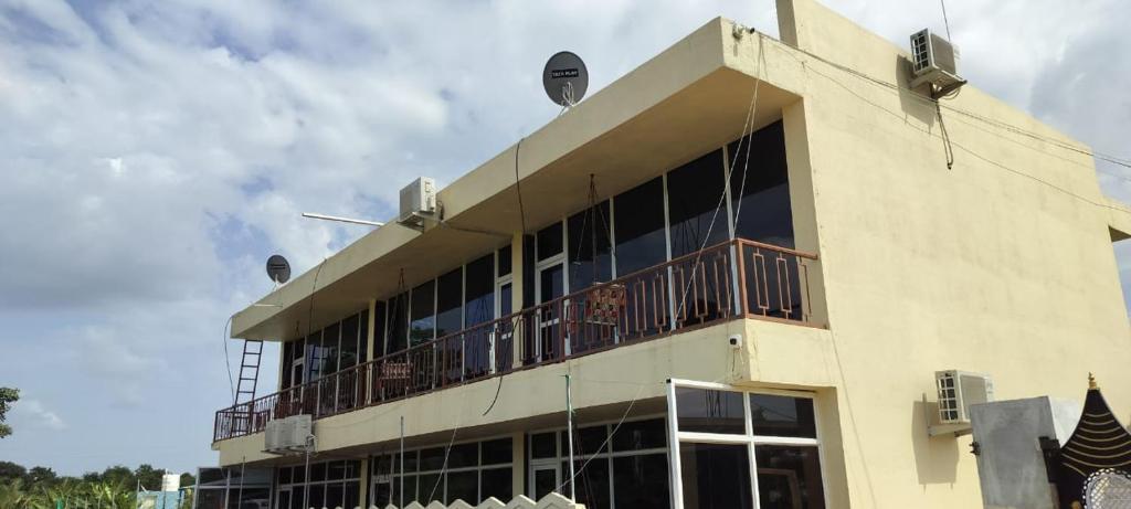a building with a balcony on the side of it at arham farm in Jāmb