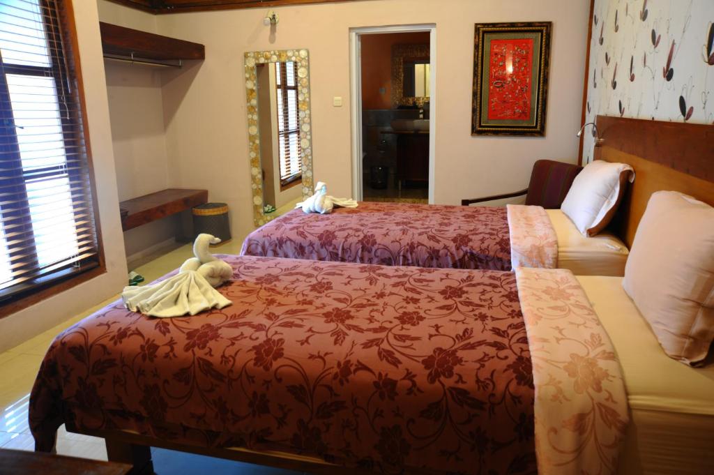 Postel nebo postele na pokoji v ubytování Tegal Panggung Guest House