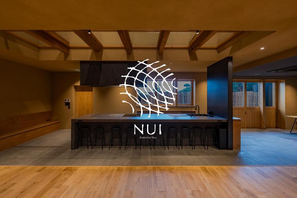 a nunit sign on a table in a room at Nui in Minamiawaji