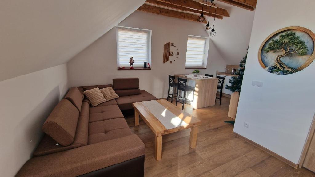 a living room with a couch and a table at Apartament nr 1 Pod Złotym Groniem in Istebna
