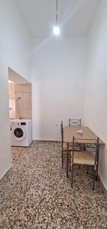 a dining room with a table and a microwave at Niki's Cozy Home in Kalymnos