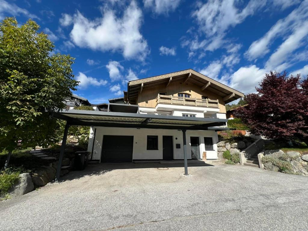 a house sitting on top of a driveway at Tauernchalet-S'Hoamatl in Hollersbach im Pinzgau