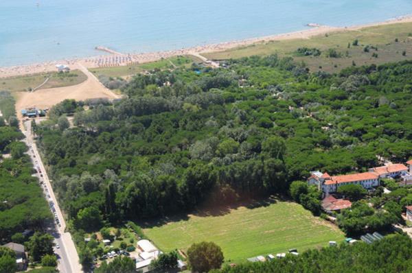 an aerial view of a house and a field and the ocean at Hotel Valdor in Cavallino-Treporti