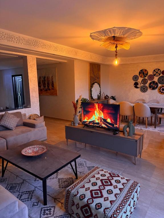 a living room with a fire in the fireplace at Charming Bohemian hideaway in Marrakech in Marrakesh