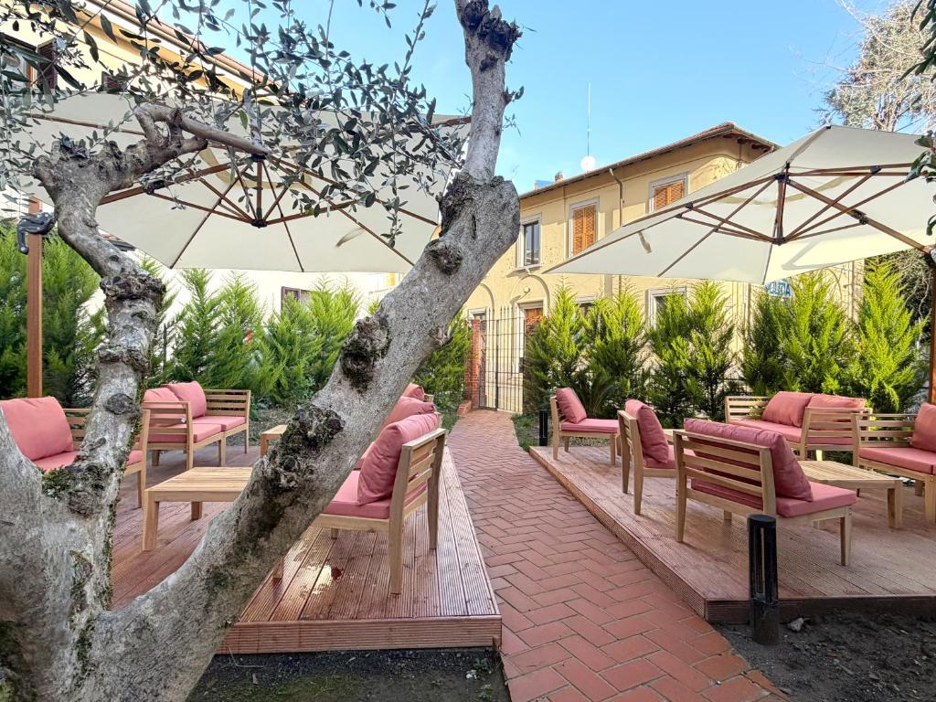 a row of chairs and umbrellas on a patio at Palazzo Garbusi in Sarzana