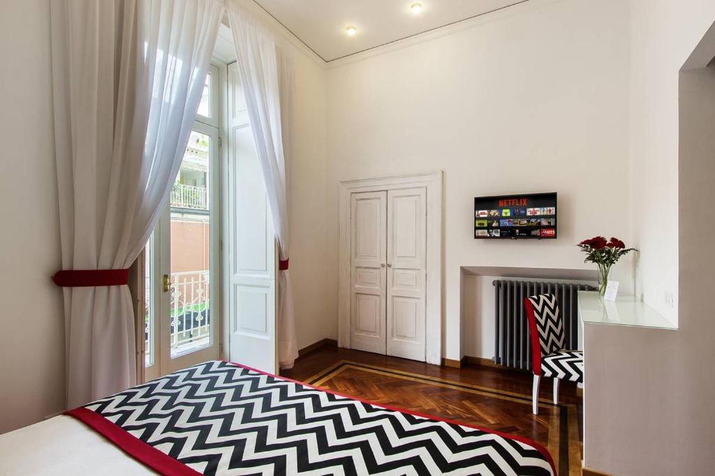 a living room with a fireplace and a window at Otium in Sorrento in Sorrento