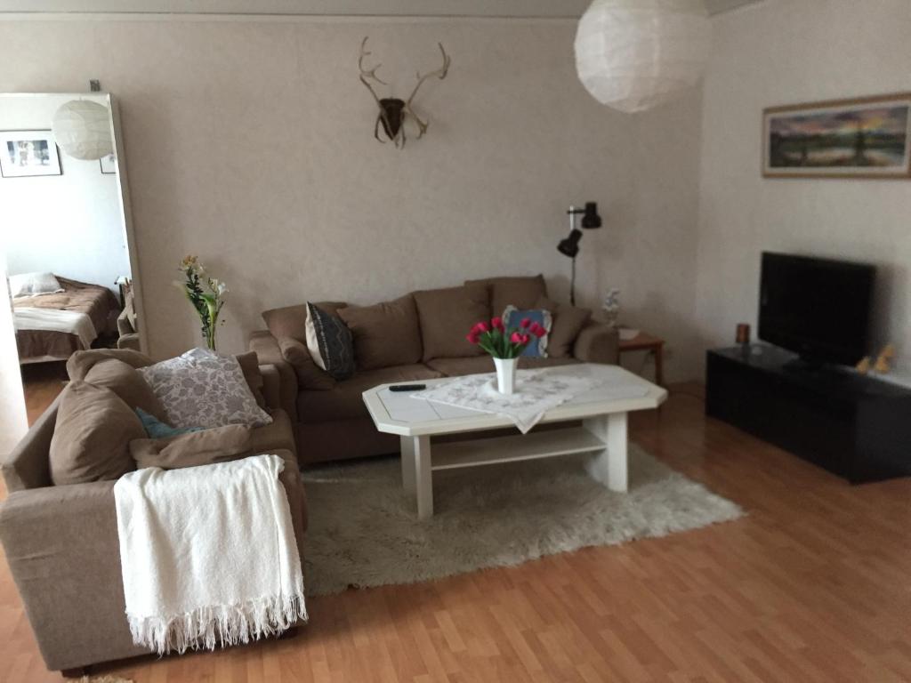 a living room with a couch and a coffee table at Lexe 2rok in Gävle