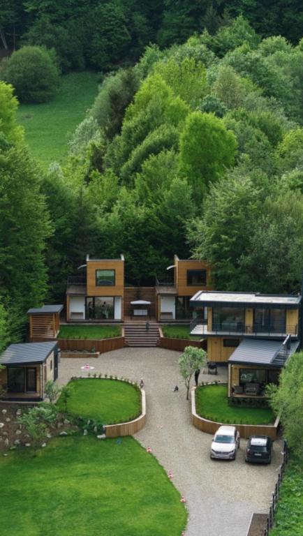 arial view of a house with cars parked in a driveway at Panoramic Kub Sucevita in Suceviţa