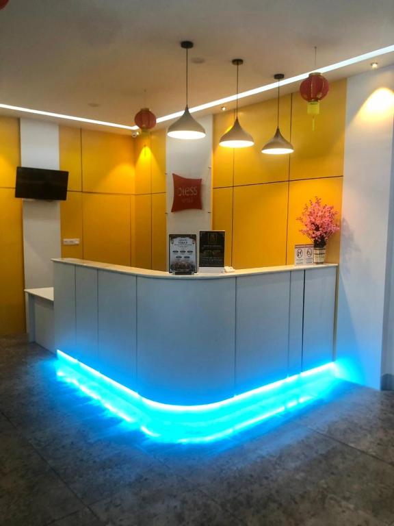 a lobby with a blue lighted counter in a room at Bless Red Hotels in Sintang