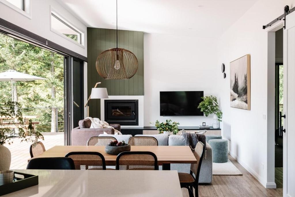 a living room with a table and a couch at Aspen Lodge Bright in Bright