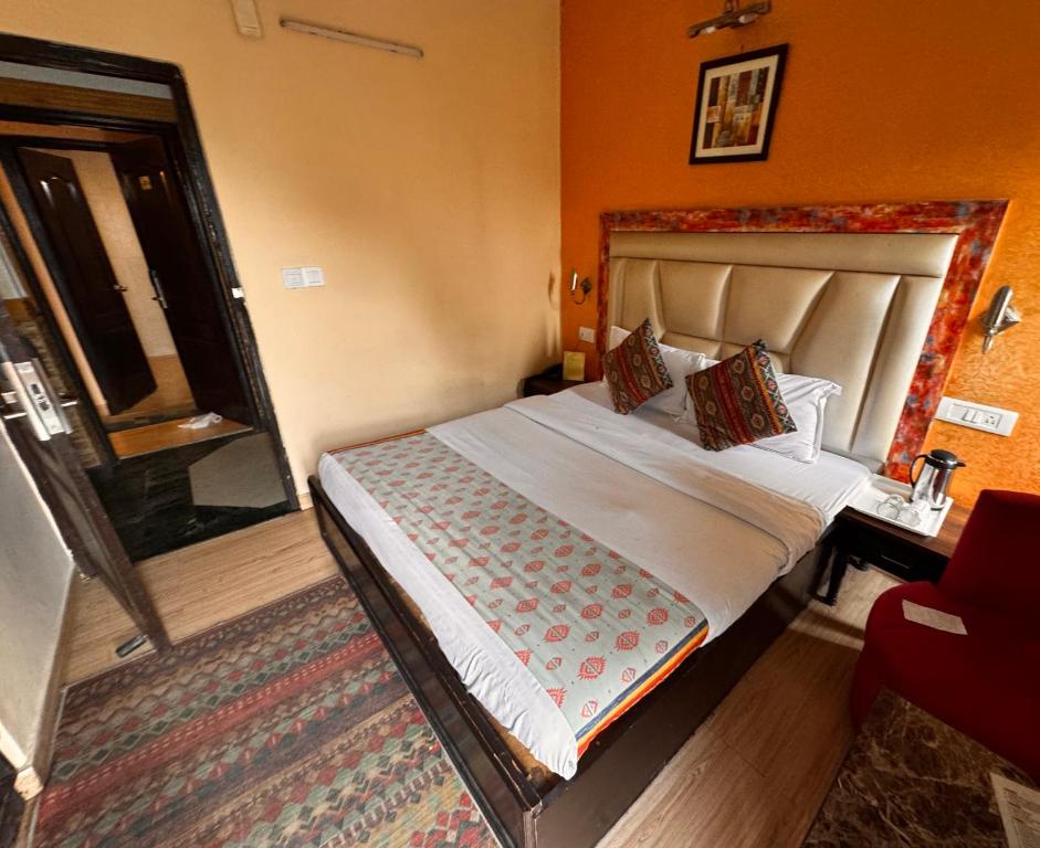 a bedroom with a bed in a room with a window at mount wood heritage in Dharmsāla