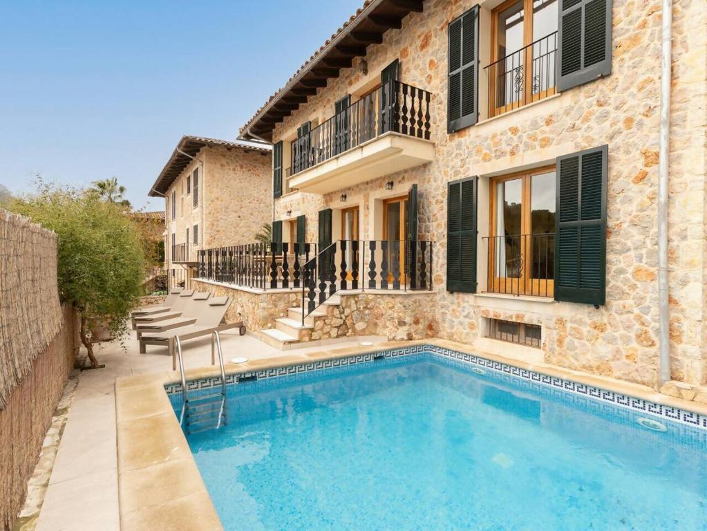a house with a swimming pool next to a building at Casa "Valldemossa Paradise" in Valldemossa