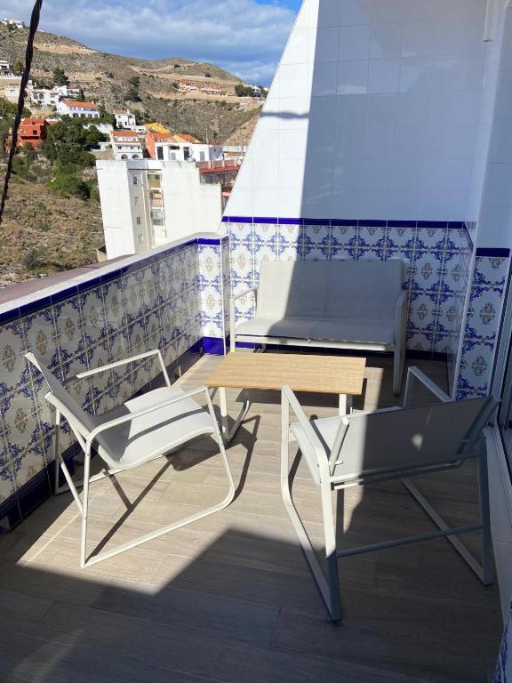a table and two chairs on a balcony with a view at Europa A- 12º-23 in Cullera