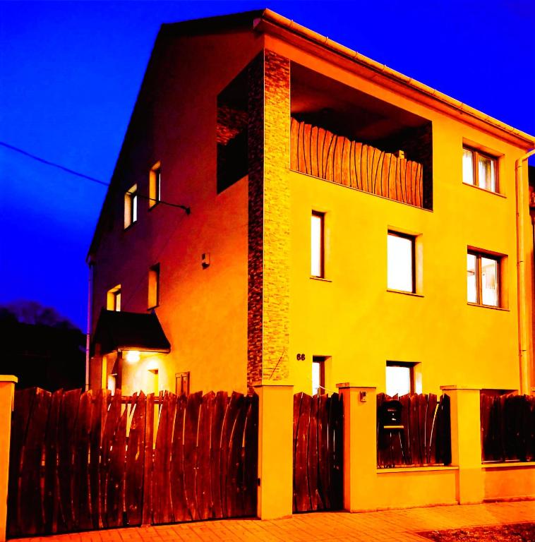 a building with a fence in front of it at Indira Vendégház in Nyíregyháza