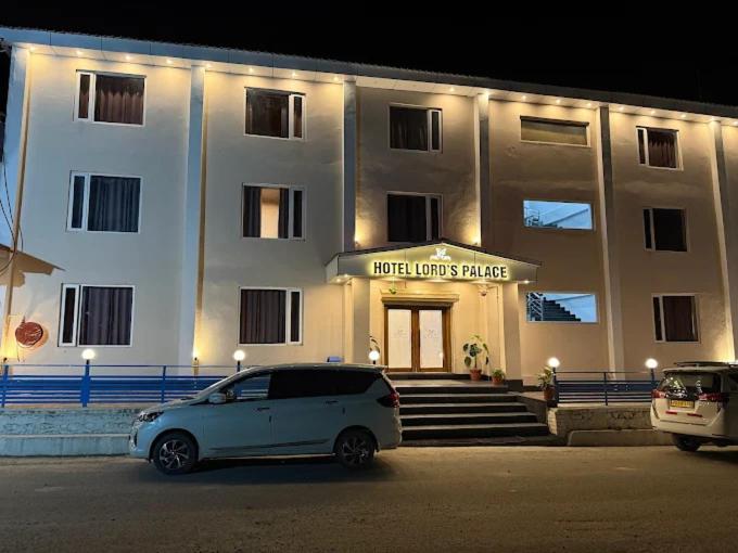 a white car parked in front of a building at VijayLord's palace Badrinath in Badrinath