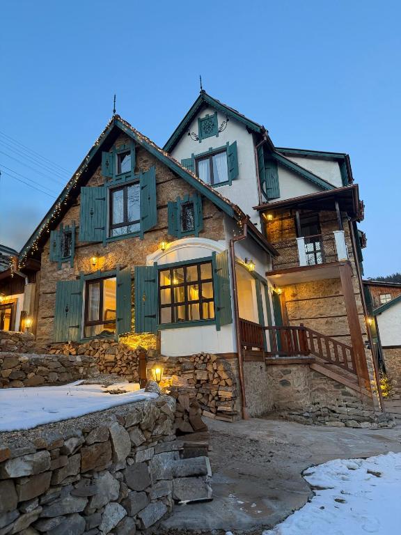 a large stone house with green shuttered windows at Happy House Progled in Progled