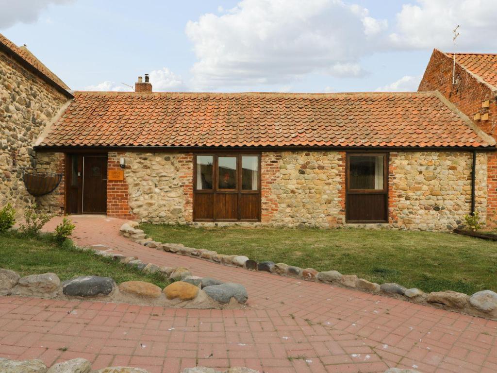 a brick house with a brick path in front of it at Daisy Nook in Hull