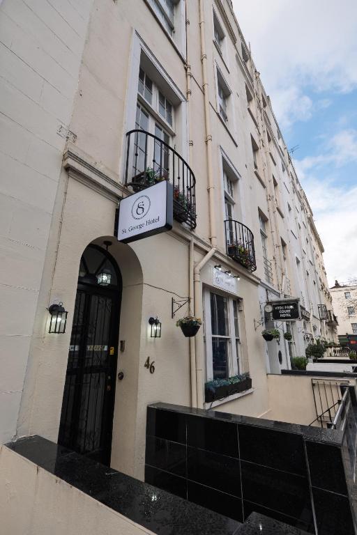 a building with a sign on the side of it at St George Hotel Paddington in London