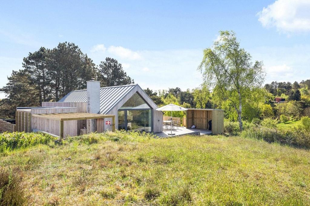 a house on a hill with a view of a field at Holiday Home Overlooking Ebeltoft Bay in Ebeltoft